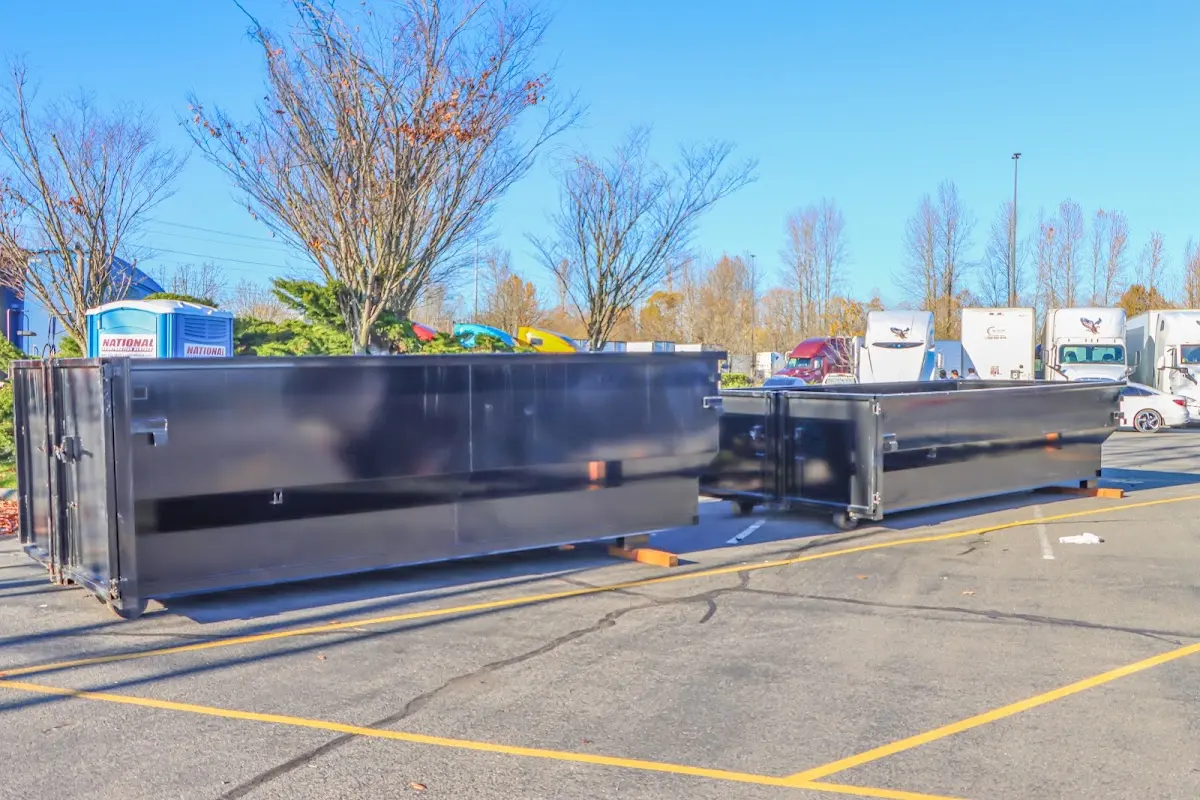 Professional dumpster rental service with roll-off container on residential driveway in Park Forest